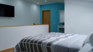 מיטה או מיטות בחדר ב-Casa Solveira