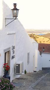 a white building with a street light on it at Casa Tia Anica in Monsaraz