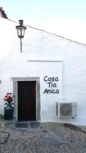 a sign on the side of a white building at Casa Tia Anica in Monsaraz
