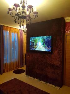 a living room with a flat screen tv on a wall at Studios Zornitsa Burgas in Burgas