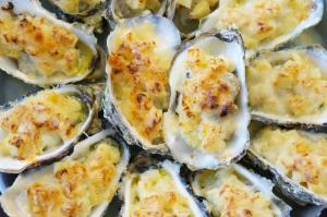 a bunch of oysters with cheese on them at Campement Hakuna Lodge in Mar Lodj