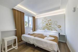 Łóżko lub łóżka w pokoju w obiekcie Welikehotel Triton Beach