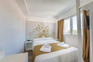 Łóżko lub łóżka w pokoju w obiekcie Welikehotel Triton Beach