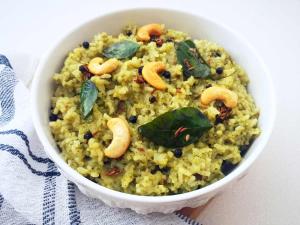 a white bowl of rice with nuts and leaves at Hotel RR International in Bangalore