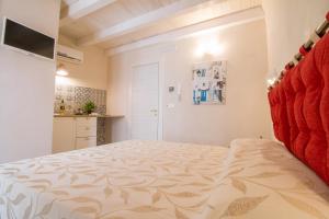 a bedroom with a bed and a kitchen at HolidayMonopoli in Monopoli