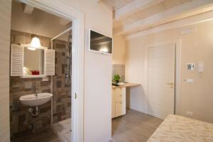 a bathroom with a sink and a toilet at HolidayMonopoli in Monopoli