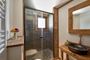 a bathroom with a glass shower and a sink at Chalet Sandy in Les Gets +23 photos