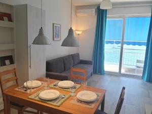 a living room with a table and a couch at Two Palms Apartment in Sutomore