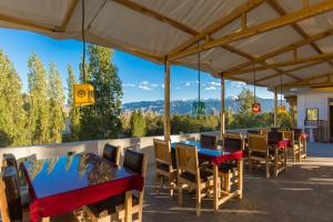 a group of tables and chairs on a patio at Zostel Leh in Leh