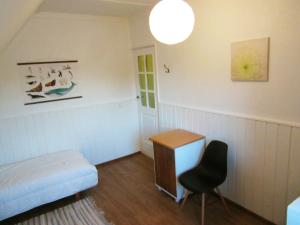 a bedroom with a bed and a desk and a chair at Villa Lille in Pärnu +17 photos
