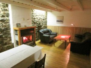 a living room with a fireplace and a couch and chairs at Villa Lille in Pärnu