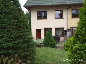 a house with two christmas trees in the yard at Zubrzyk in Łukęcin