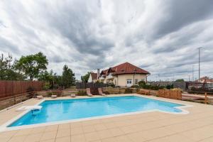 a swimming pool in front of a house at Penzion Šalamoun in Jevišovice