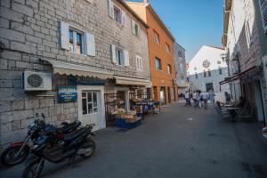 a motorcycle parked next to a building on a street at Apartment Antea in Sinj