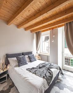 sypialnia z dużym łóżkiem i drewnianym sufitem w obiekcie La Casa Della Zia w mieście Sarnico