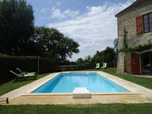 a swimming pool in the yard of a house at Studio Du Cluzel in Pontcirq
