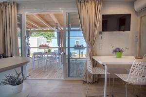 a living room with a table and chairs and a patio at Valamar Camping Baška in Baška +29 photos