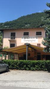 a building with a car parked in front of it at Ristorante Campagna in Cugnasco