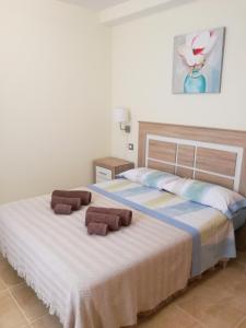 a bedroom with two beds with towels on them at Apartamento fuerte 2 in Puerto del Rosario