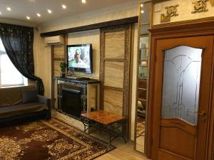 a living room with a fireplace and a television at Apartment on Sovetov 62 in Novorossiysk