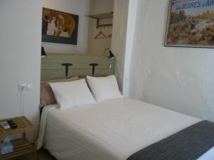 a small bedroom with a bed and a night stand at No 31 Bed & Breakfast in Olvera