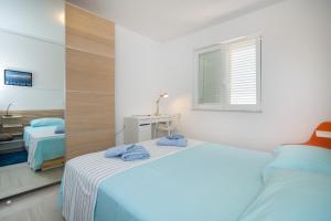 Postel nebo postele na pokoji v ubytování Apartments Tamburini