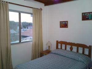 Postel nebo postele na pokoji v ubytování La Perla