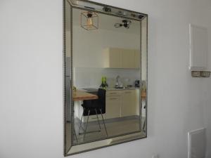 a mirror on a wall with a kitchen and a table at ERA home boutique in Eilat +57 photos