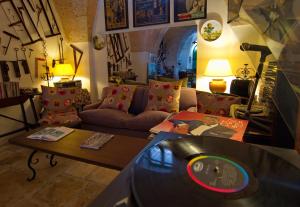 a living room with a cd sitting on a table at Masseria Il Frantoio in Ostuni