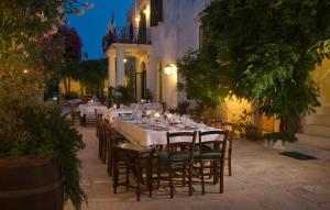 a long table with chairs and plates of food at Masseria Il Frantoio in Ostuni