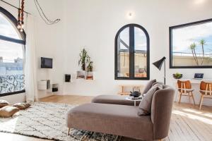 a living room with a couch and a table at DestinationBCN Marimon Apartment in Barcelona