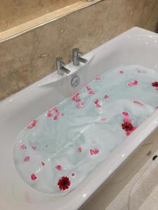 a white sink with pink flowers in it at The Firs Guesthouse in Runswick