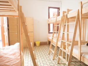 a bunk bed in a room with wooden floors at Lua Lua Hostel Las Palmas in Las Palmas de Gran Canaria