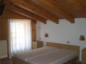 a bedroom with a bed and a window at Hotel Edelweiss in Passo del Tonale