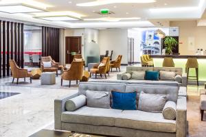 a hotel lobby with couches and chairs at Empire Lisbon Hotel in Lisbon