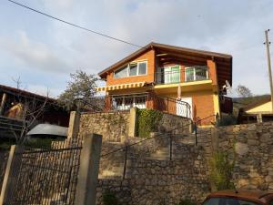 a house on top of a stone wall at Apartment Forest and Lake in Lagadin
