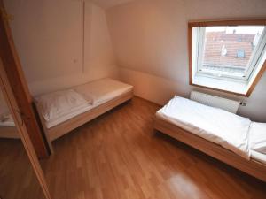 a small room with two beds and a window at AB Apartment Objekt 76 in Fellbach