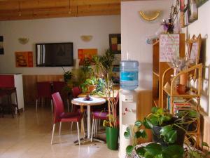 a room with a table, chairs, and a television at Hostal Platja in Cambrils