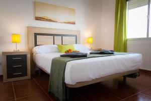 A bed or beds in a room at Holidays2Torremolinos Apartamento de 3 dormitorios con terraza y piscina comunitaria