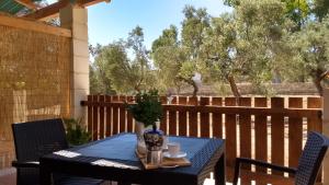a table with a blue table cloth on a patio at Agriturismo Le Scerze in Borgagne