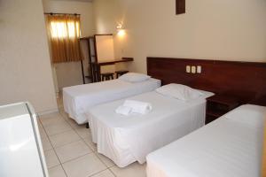 Un pat sau paturi într-o cameră la Hotel Varandas Araraquara
