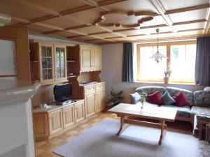 a living room with a couch and a table at Ferienwohnung Annele in Hittisau