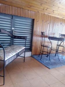a group of chairs and tables in a room with a garage at Hotel JF in Pirassununga