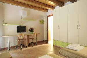 a bedroom with a desk with a computer and two chairs at Residence Cavazza in Bologna +22 photos