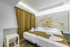 Łóżko lub łóżka w pokoju w obiekcie Welikehotel Triton Beach