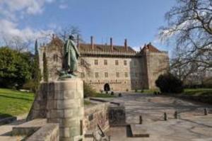 a statue in front of a large building at Casa da Lagiela rural senses in Fafe