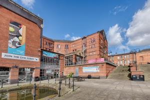 a large brick building with a staircase in front of it at Castlefield Hotel in Manchester
