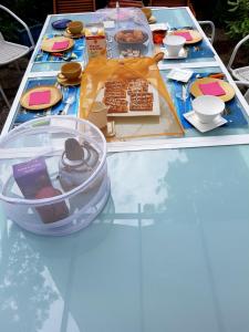 a table with cakes and desserts on top of it at Villa Akwaba in Pyla-sur-Mer