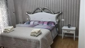 a bedroom with a bed with towels on it at Donna Margharet in Crotone