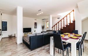 a dining room and living room with a table and chairs at Villa Pistan in Murvica
